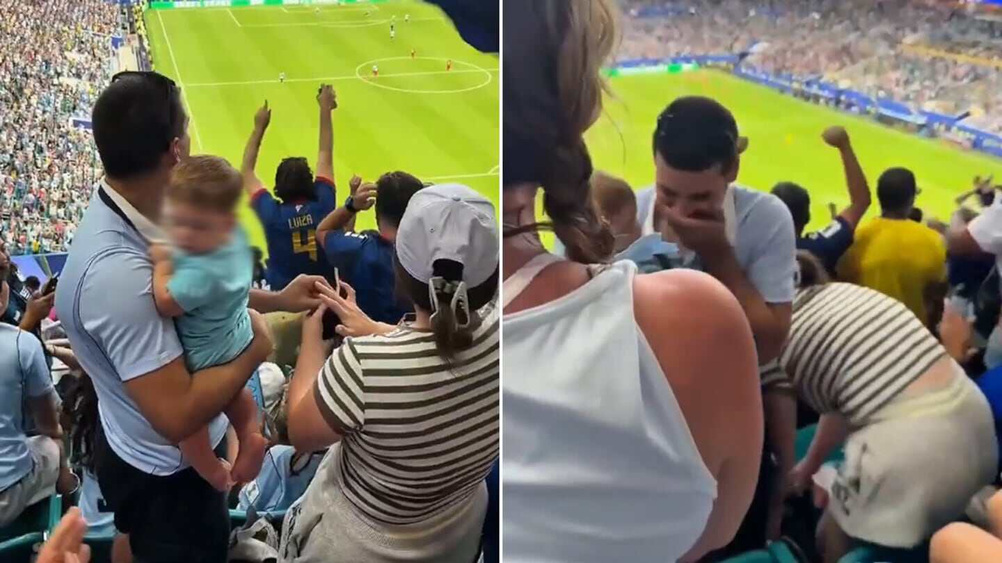 Pareja uruguaya en la tribuna durante un partido del Mundial 2026, con un momento de propuesta de matrimonio
