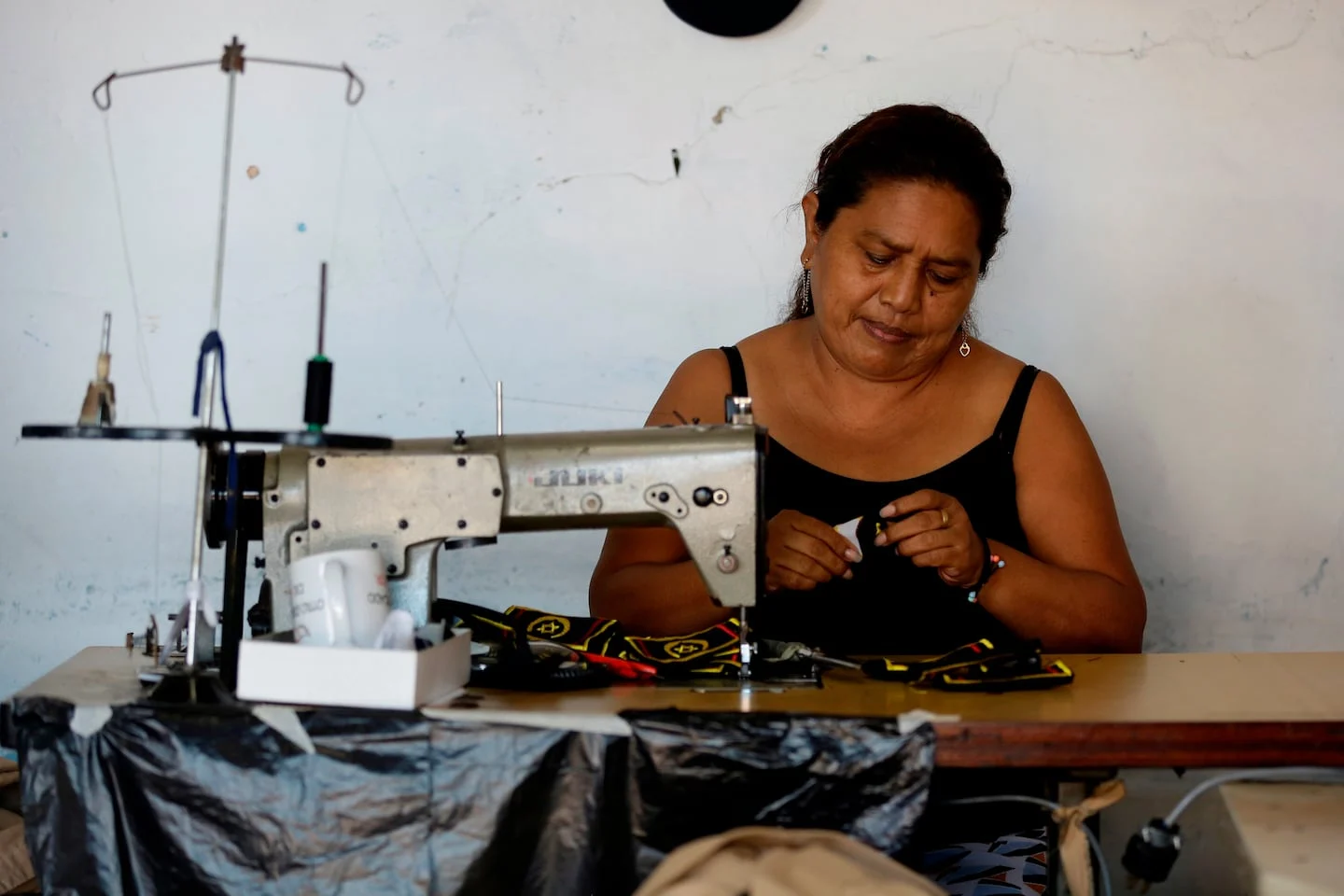 Mujer trabajando en una máquina de coser en un taller