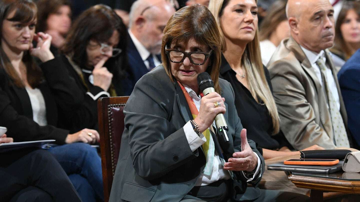 Una legisladora en el Congreso sostiene un micrófono mientras habla durante una sesión