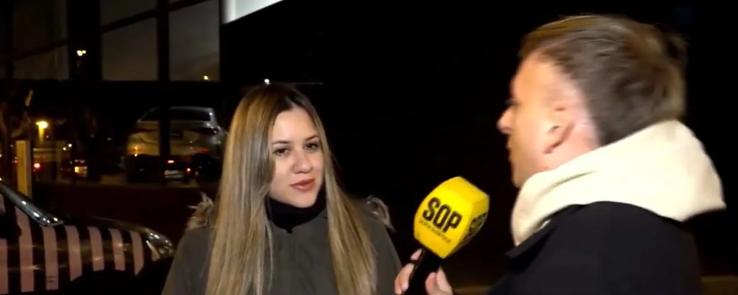 Entrevista a una mujer con cabello largo y lacio, mientras sostiene un micrófono amarillo