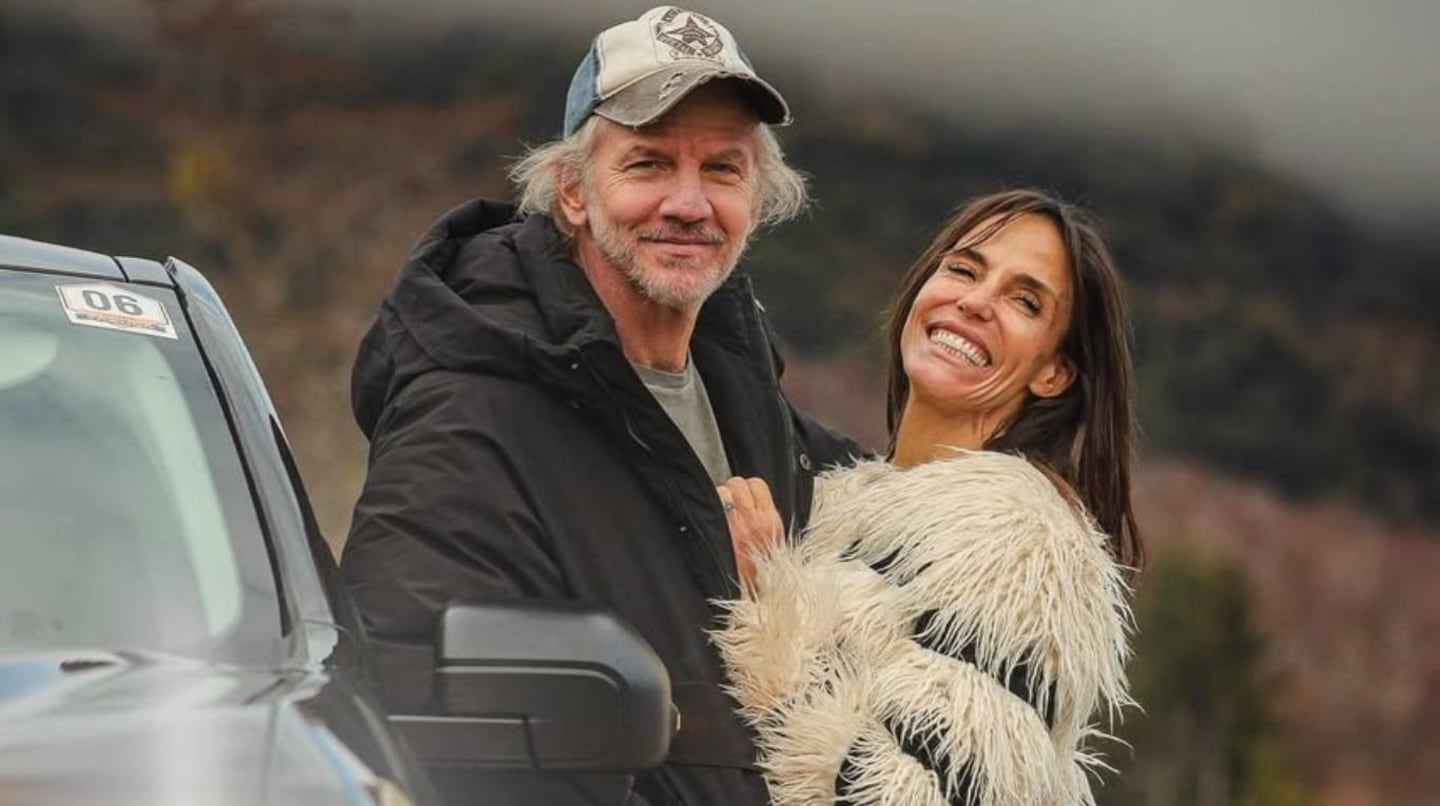 Facundo Arana y María Susini sonríen juntos al aire libre junto a un vehículo