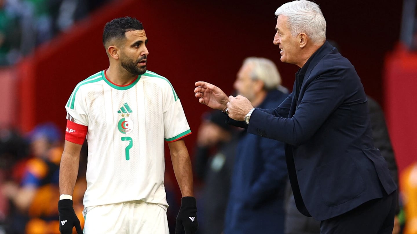 Entrenador de fútbol habla con jugador durante un partido
