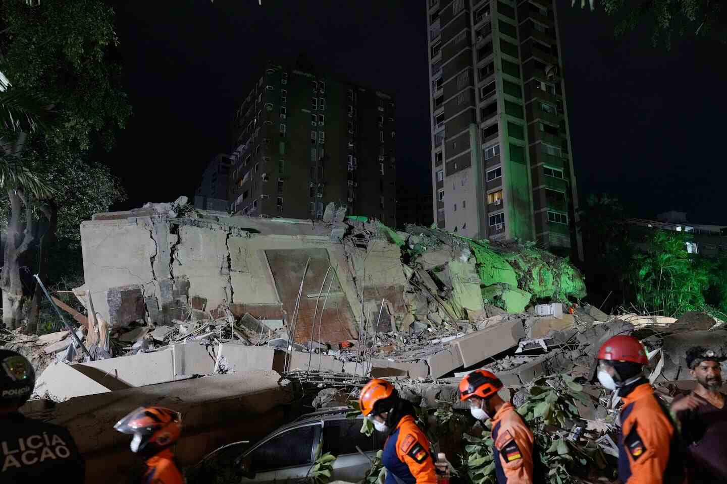 Derrumbe de un edificio en Caracas tras un terremoto, con rescatistas en primer plano