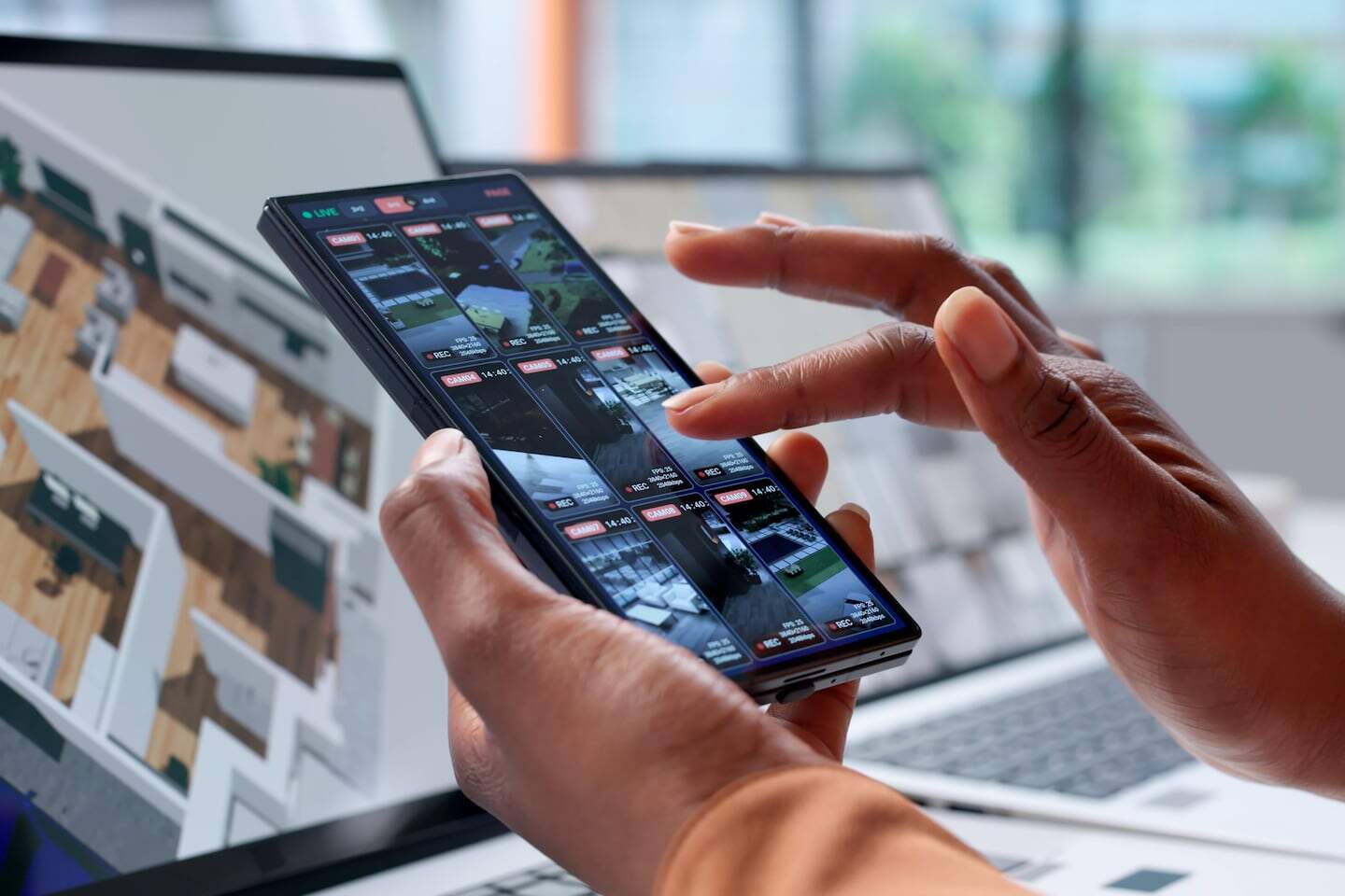Persona usando un teléfono móvil para monitorear un sistema de vigilancia con inteligencia artificial