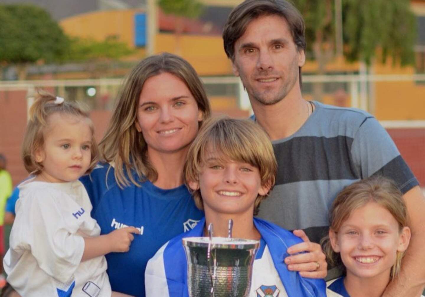 Nico Paz posando con su familia y un trofeo en manos de un niño