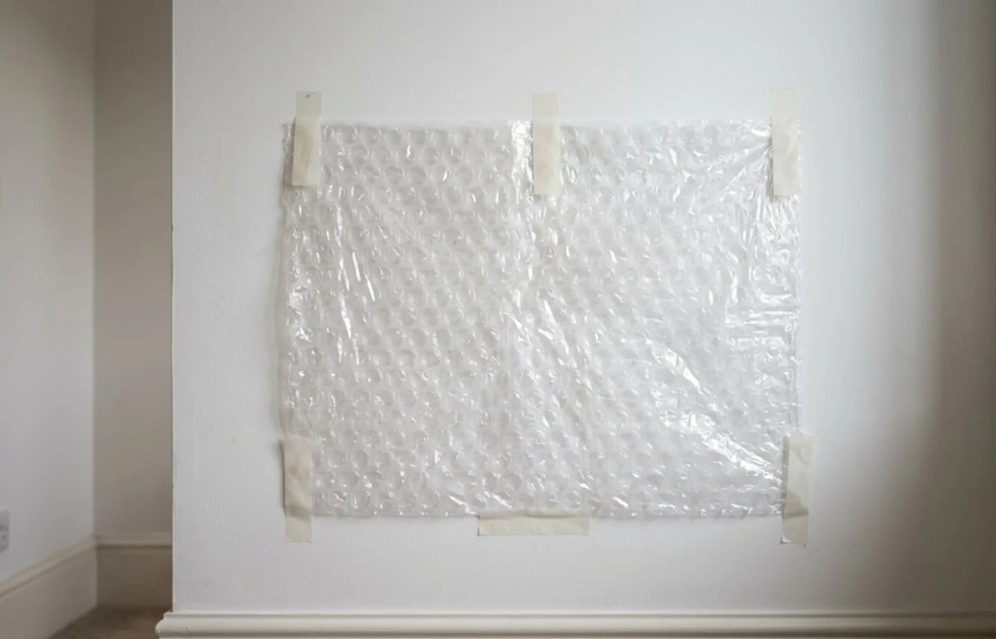Papel burbuja adherido a una pared como aislamiento térmico
