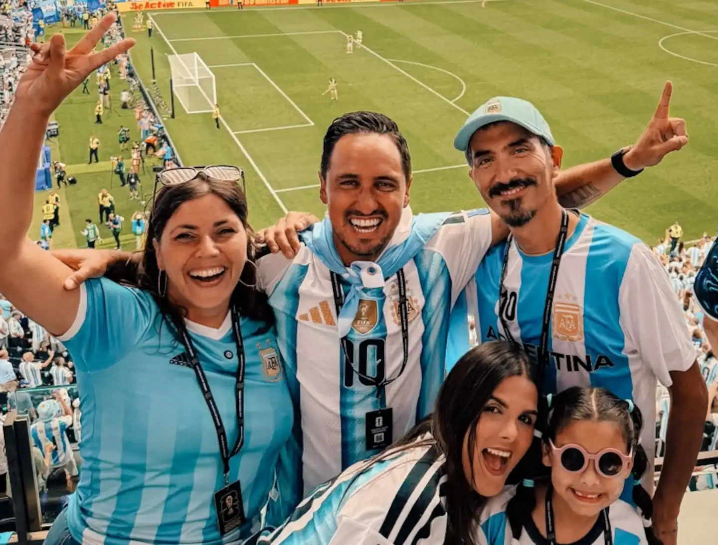 Cuatro personas sonrientes con camisetas de la selección argentina en un estadio durante el Mundial 2026
