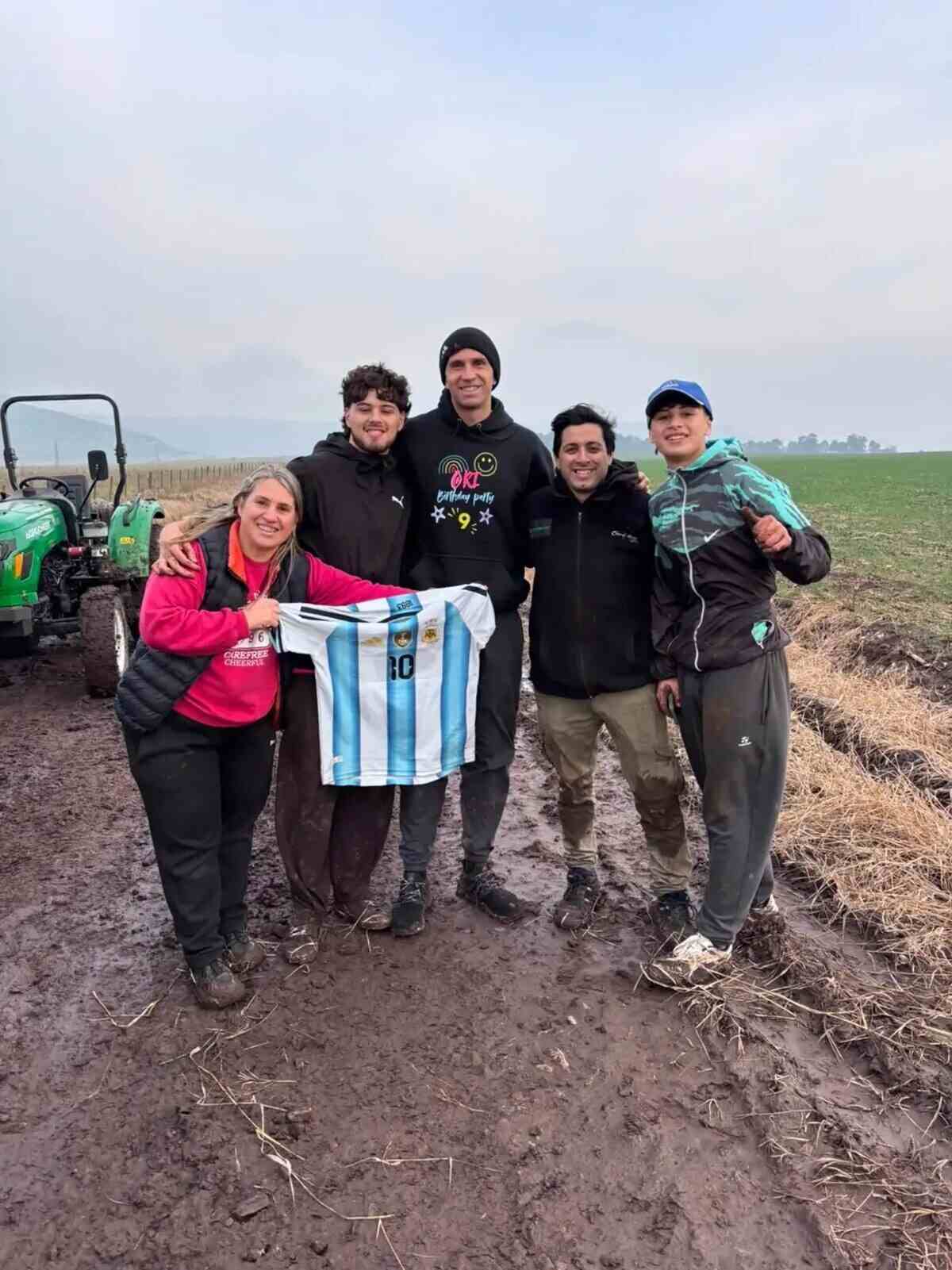 Jugadores de la Selección Argentina posando con una camiseta en un campo durante sus vacaciones