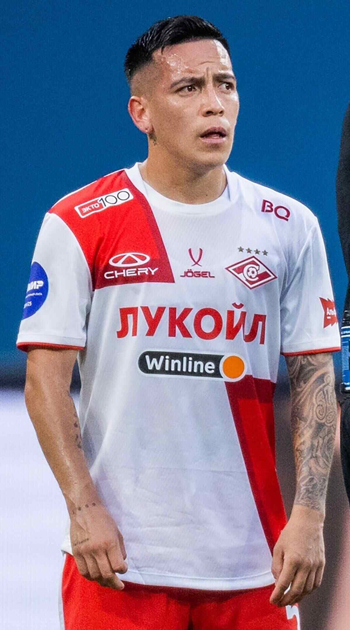 Jugador de fútbol con camiseta blanca y roja, mostrando una expresión de preocupación