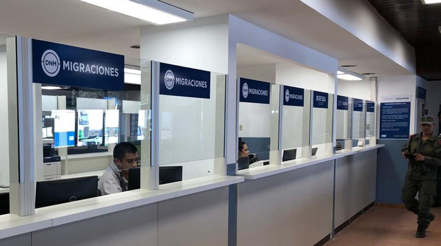 Oficina de migraciones en Argentina con personal atendiendo